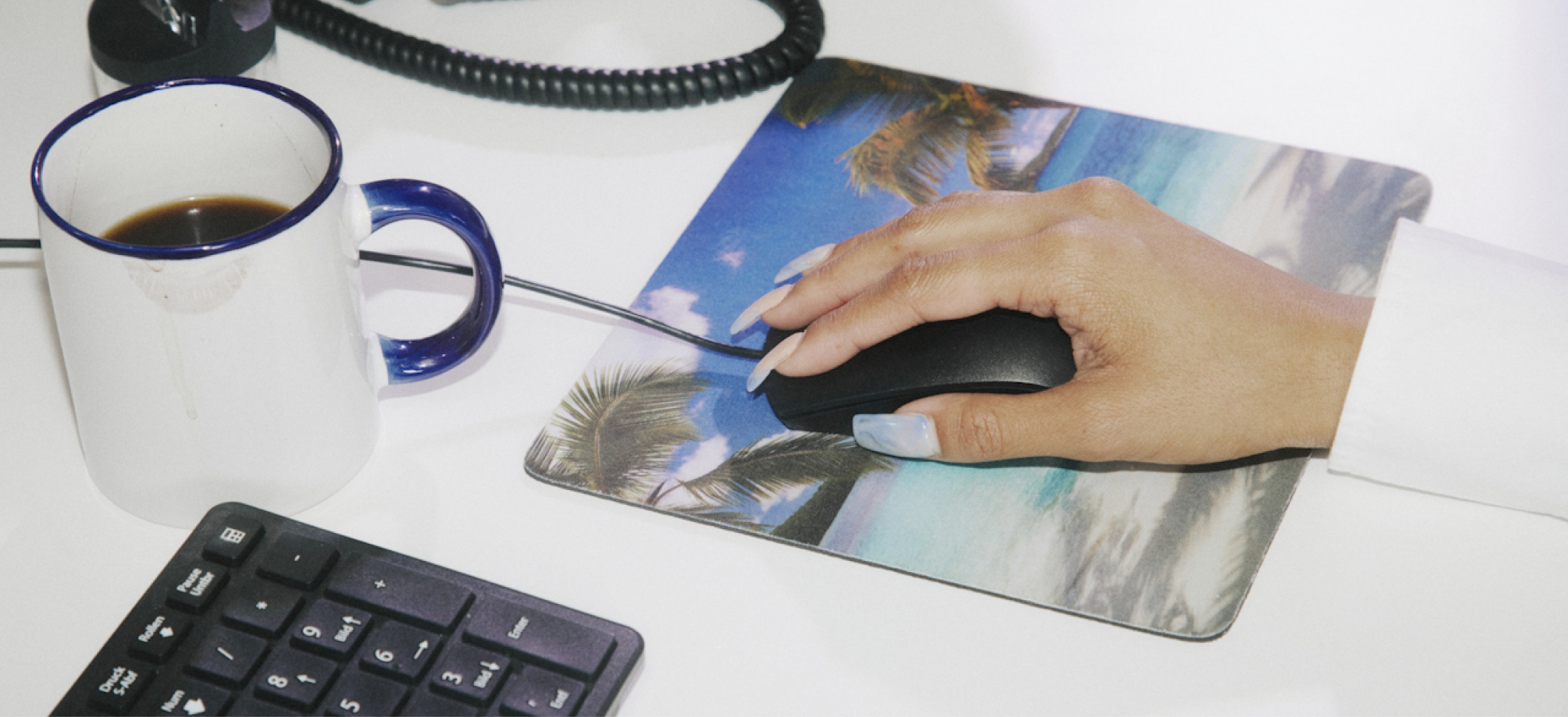 Desk with a mug, keyboard and mouse