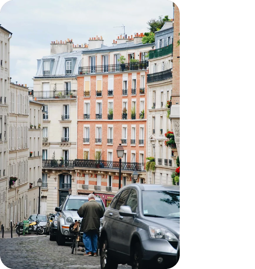 Cobbled Montmartre street lined with brick and limestone apartments in Paris