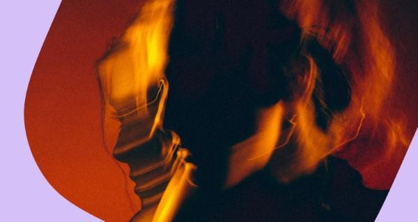 A person with a blurry face and a cell phone.