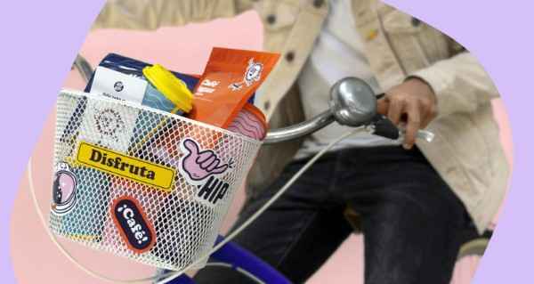 A basket of items including a bag of chips, a bag of cookies, and a bag of candy.