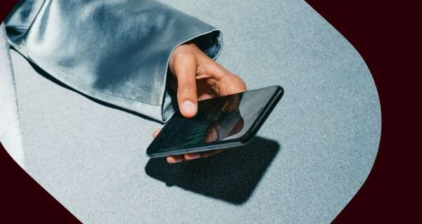 A hand holding a cell phone.