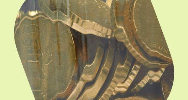 A stack of gold coins in a glass case.