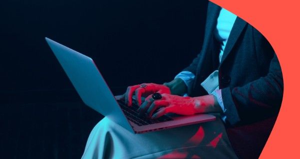 A woman is sitting in front of a laptop.