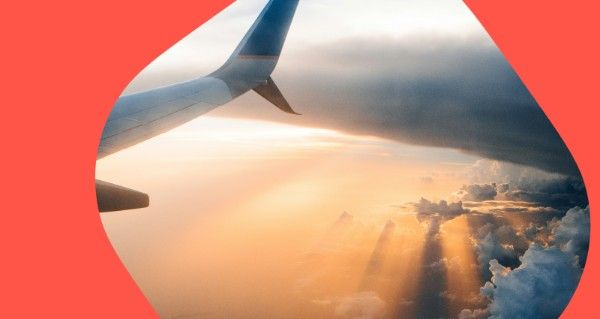 A plane wing with a sunset in the background.