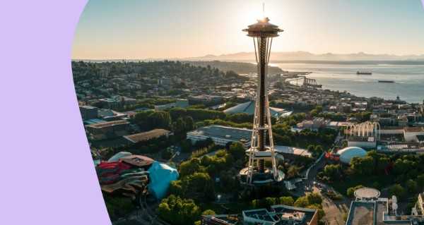 A large city with a tall tower and a bridge.