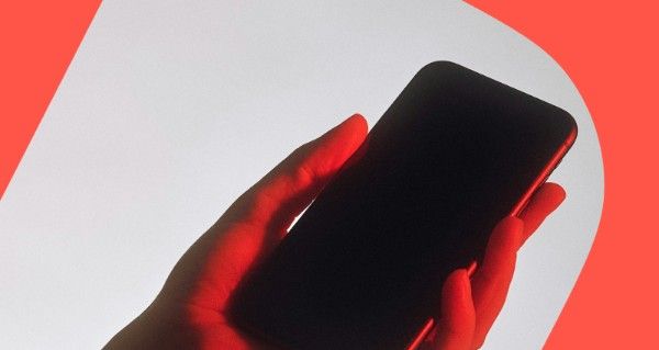 A hand holding a cell phone.