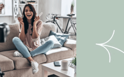 A woman sitting on a couch holding a cell phone.