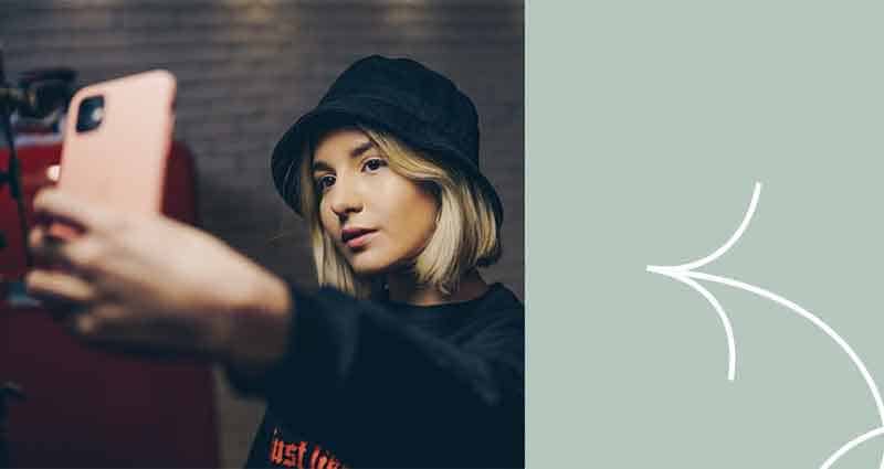 A woman wearing a black hat and a black shirt.