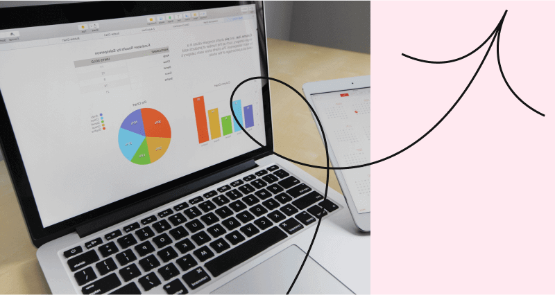 A laptop with a graph and a calendar on the screen.