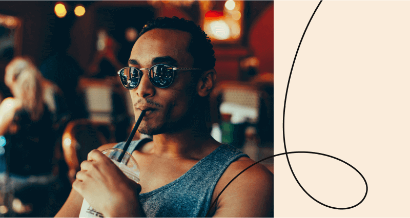 A man drinking a beverage with a straw.