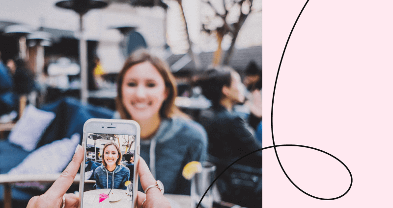 A woman is taking a selfie with her cell phone.