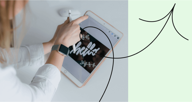 A person is drawing a letter on a tablet.