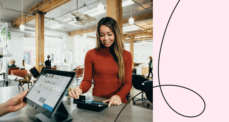 A woman is using a tablet computer at a desk.