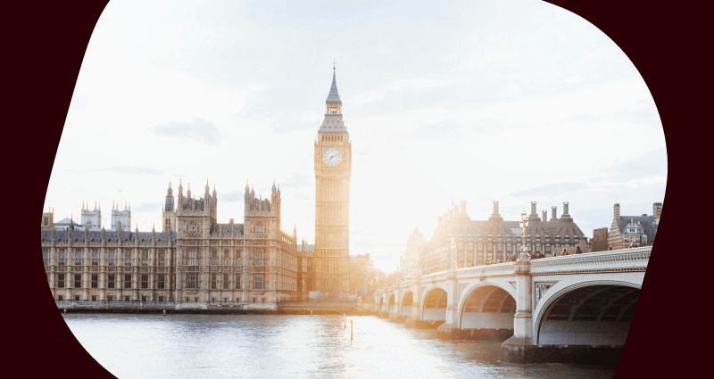 A large clock tower with a bridge in the foreground.