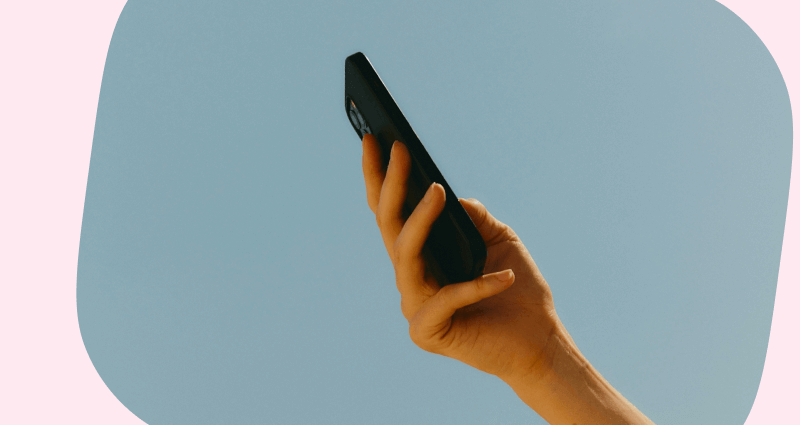 A hand holding a cell phone.