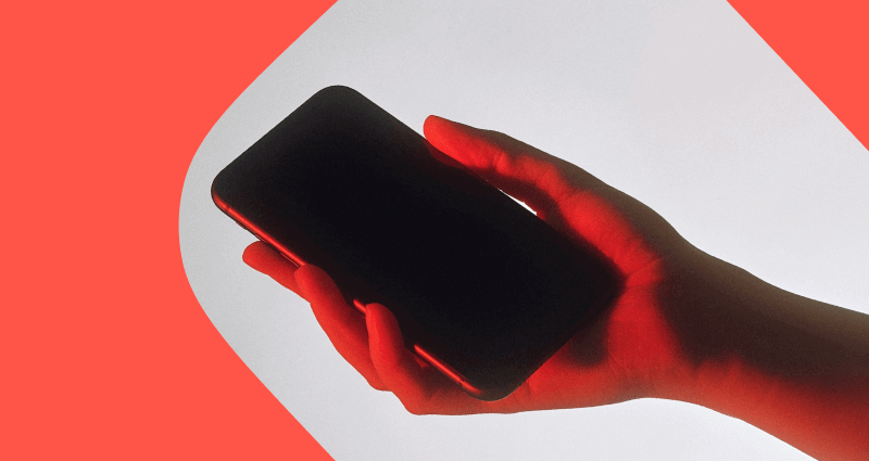 A hand holding a cell phone.