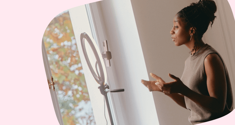A woman standing in front of a mirror.