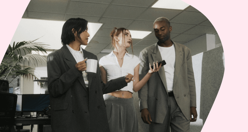 A woman in a white shirt and a man in a grey suit are talking to each other.