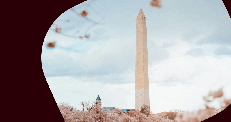A large white building with a pointed top and a blue roof.