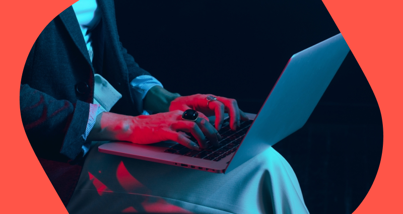 A person wearing a ring is typing on a laptop.