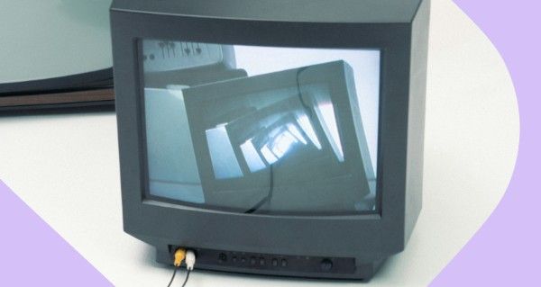 A black television with a reflection of a staircase.