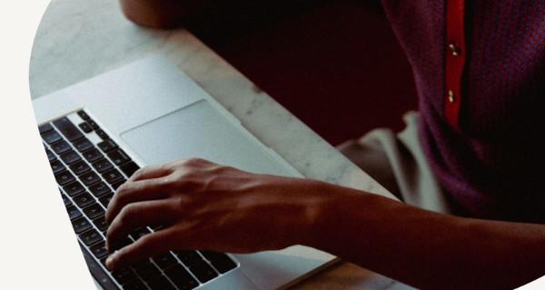 Person writing in note book