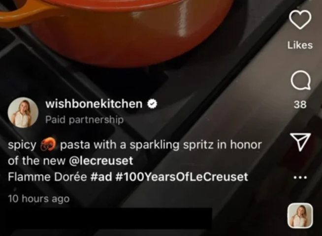 Instagram Reel by wishbonekitchen marked Paid partnership, with a caption about spicy pasta for Le Creuset’s Flamme Dorée tagged #ad and #100YearsOfLeCreuset.