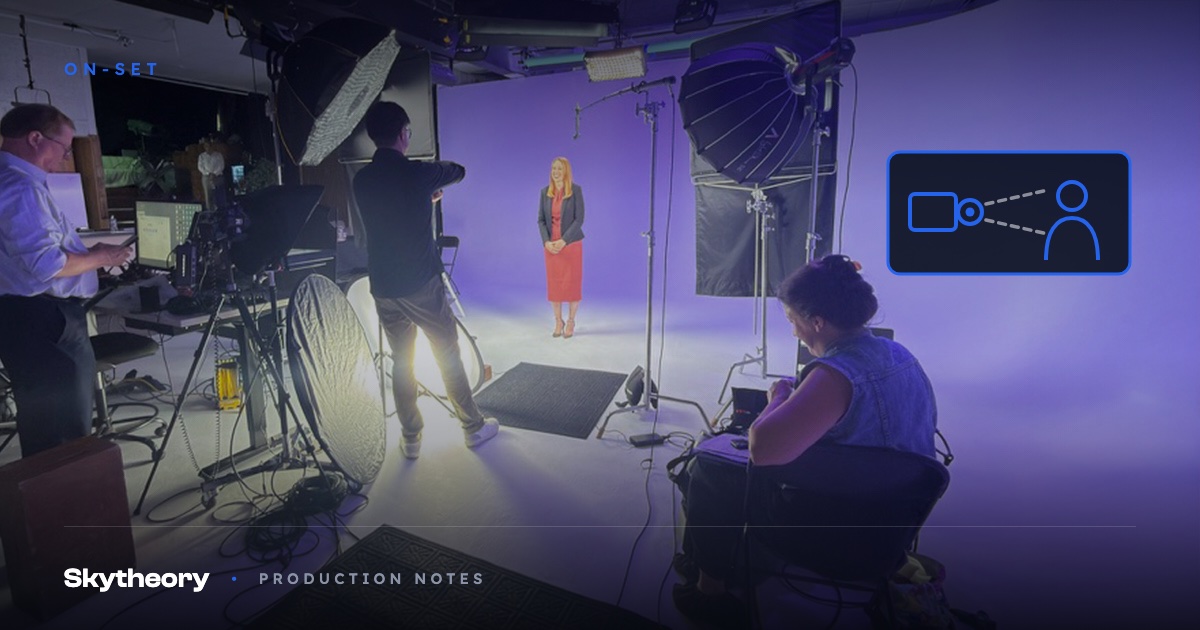 Presenter on a lavender-lit studio cyc surrounded by crew, teleprompter station, and lighting rigs during an expert recording session