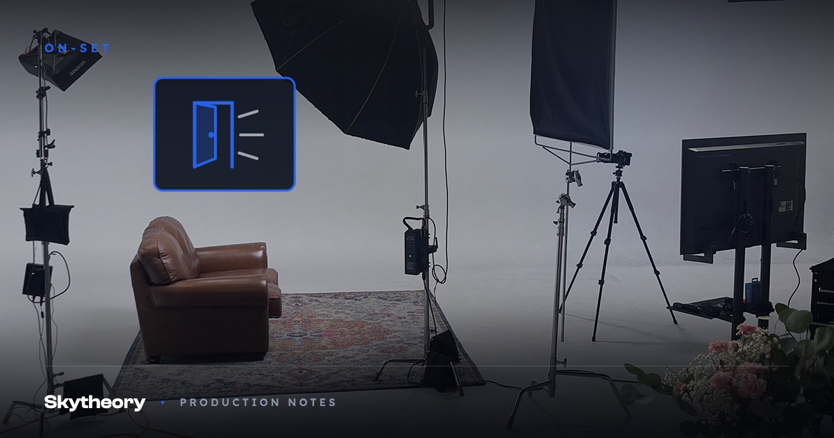Pre-lit studio set with a leather armchair on a rug, softboxes and camera rigged and ready before the client arrives, with an open door graphic
