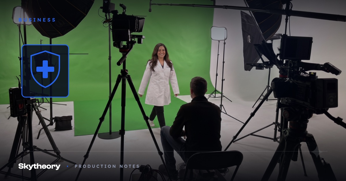Physician in a white coat on a green screen studio stage with director and multi-camera crew, with a medical shield graphic