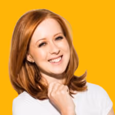 Smiling woman with red hair and white shirt against an orange background.
