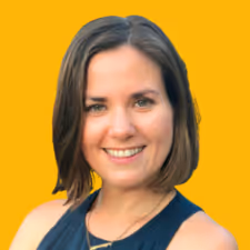 Smiling woman with short brown hair wearing a sleeveless black top against a yellow background.