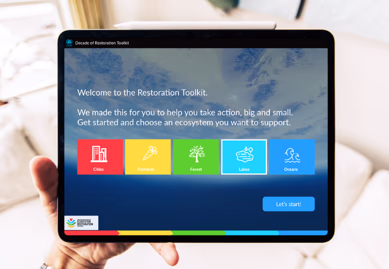 Tablet screen showing the Restoration Toolkit with options to support Cities, Farmland, Forest, Lakes, or Oceans ecosystems.