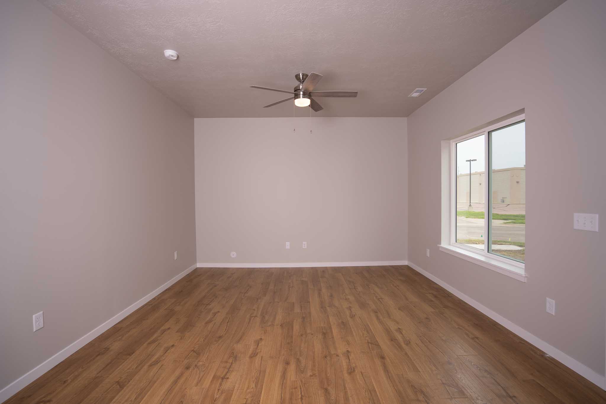 Living room with wood look flooring and plenty of natural light.