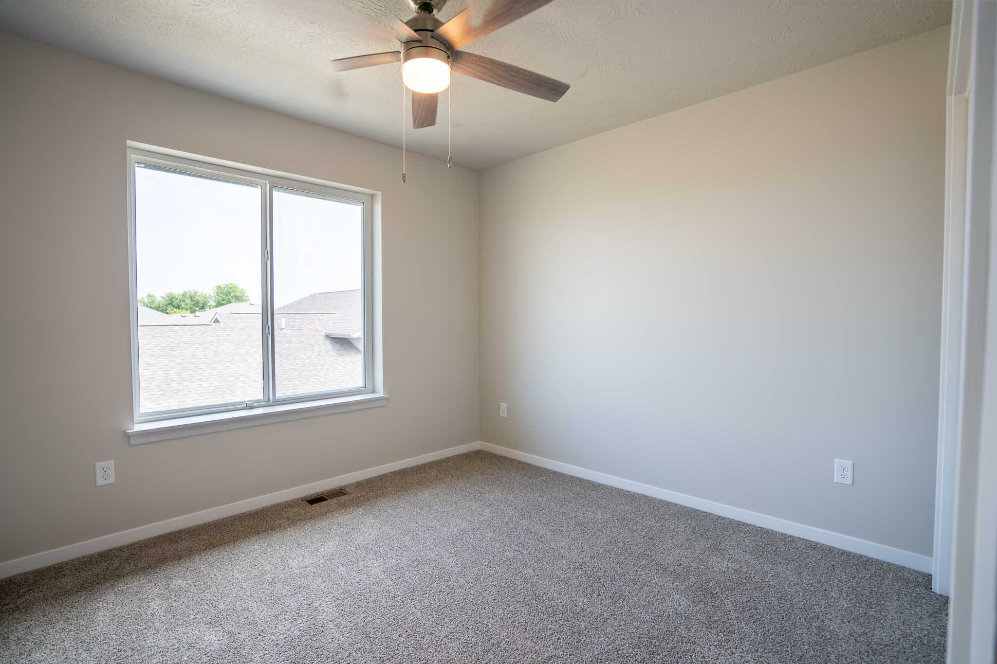 Bedroom with ceiling fan and one window.