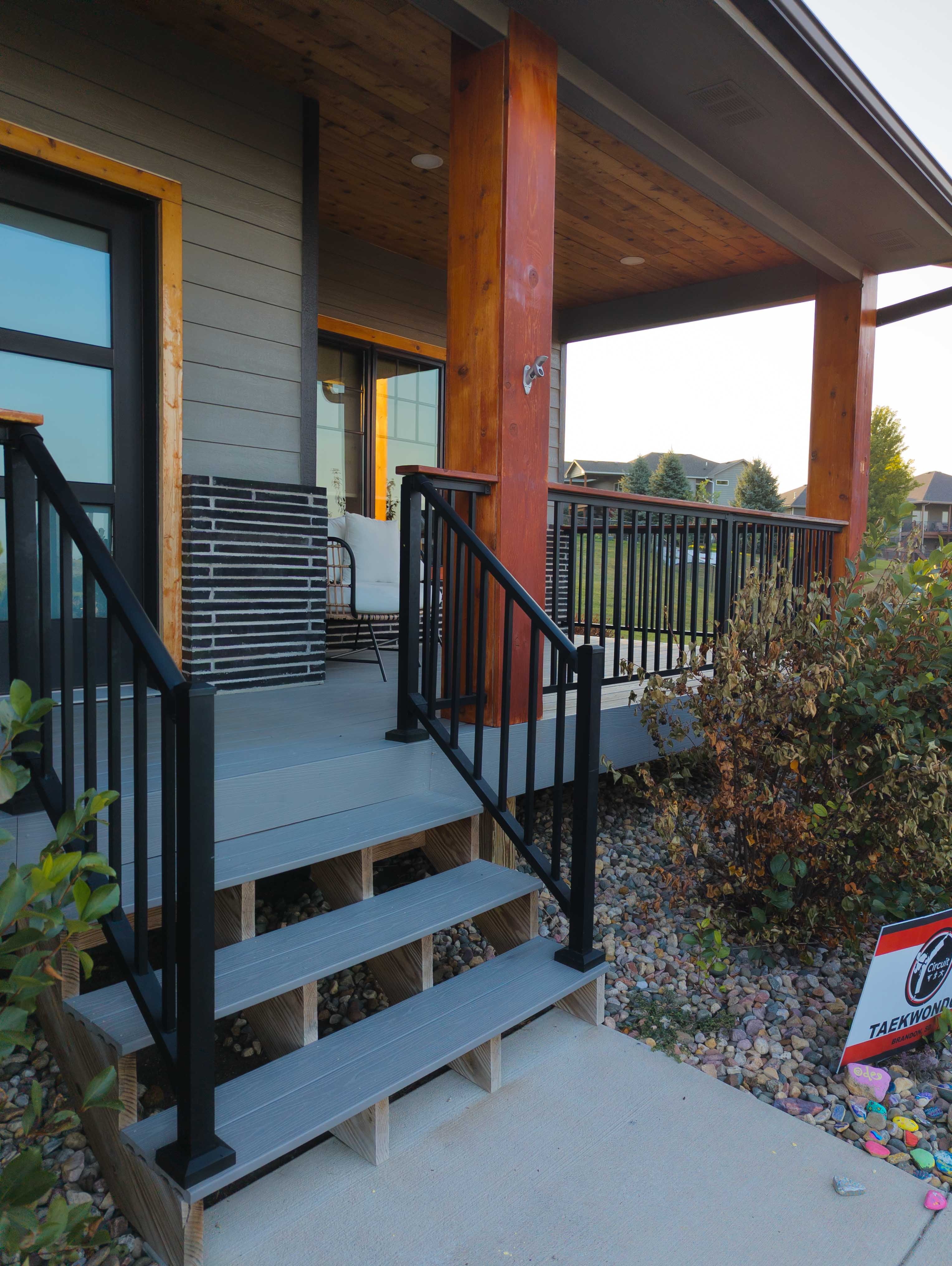 Gray composite deck with black metal railings and wood top - Brandon, SD