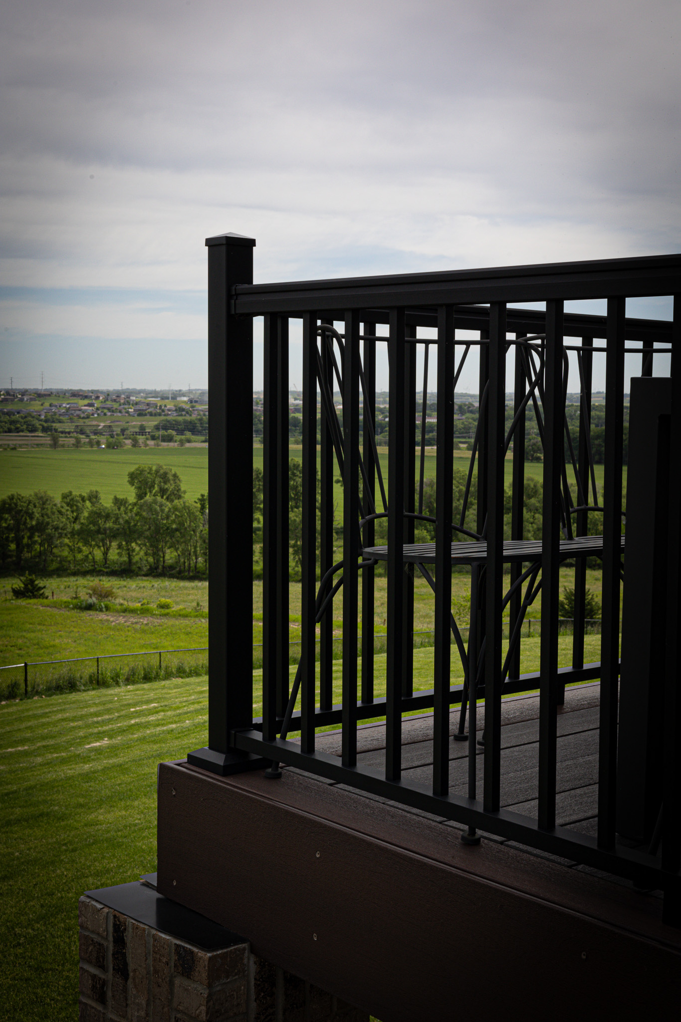 Black railing on a brown composite deck.
