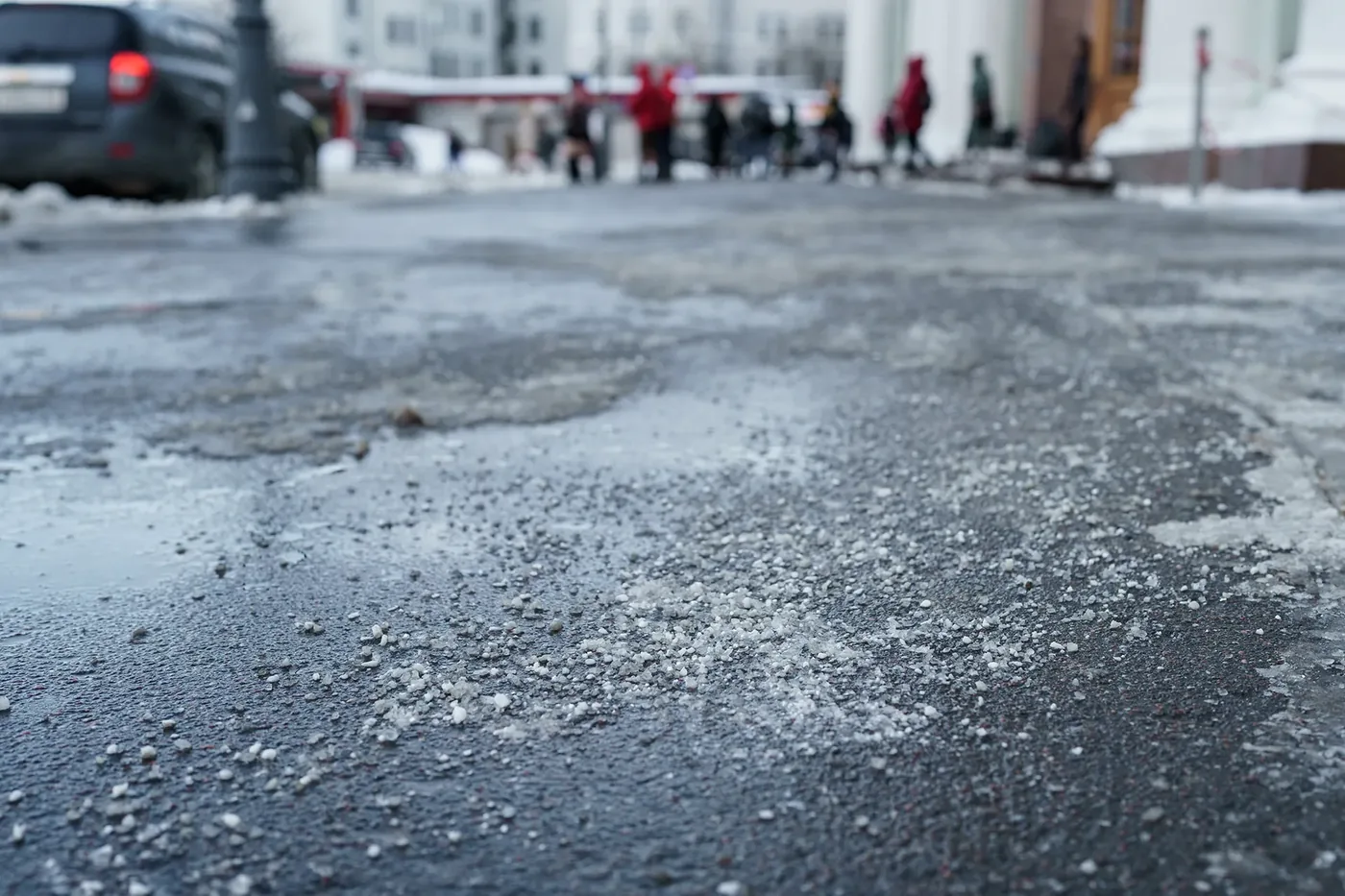 De-icing material applied to a winter roadway