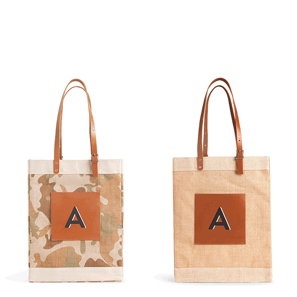 People leaving an event with their market bags