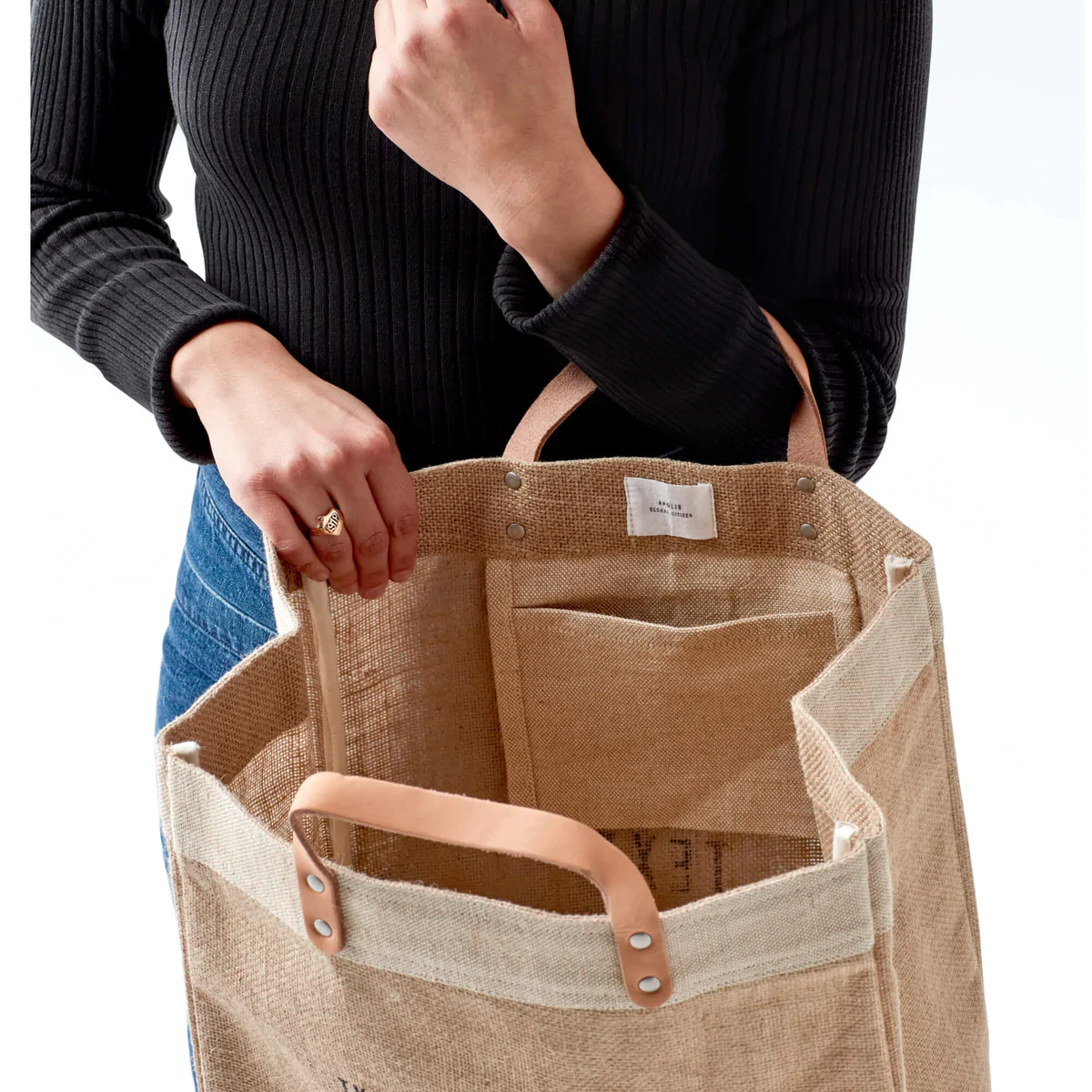 People sitting on a table enjoying friends with a market bag in front of them