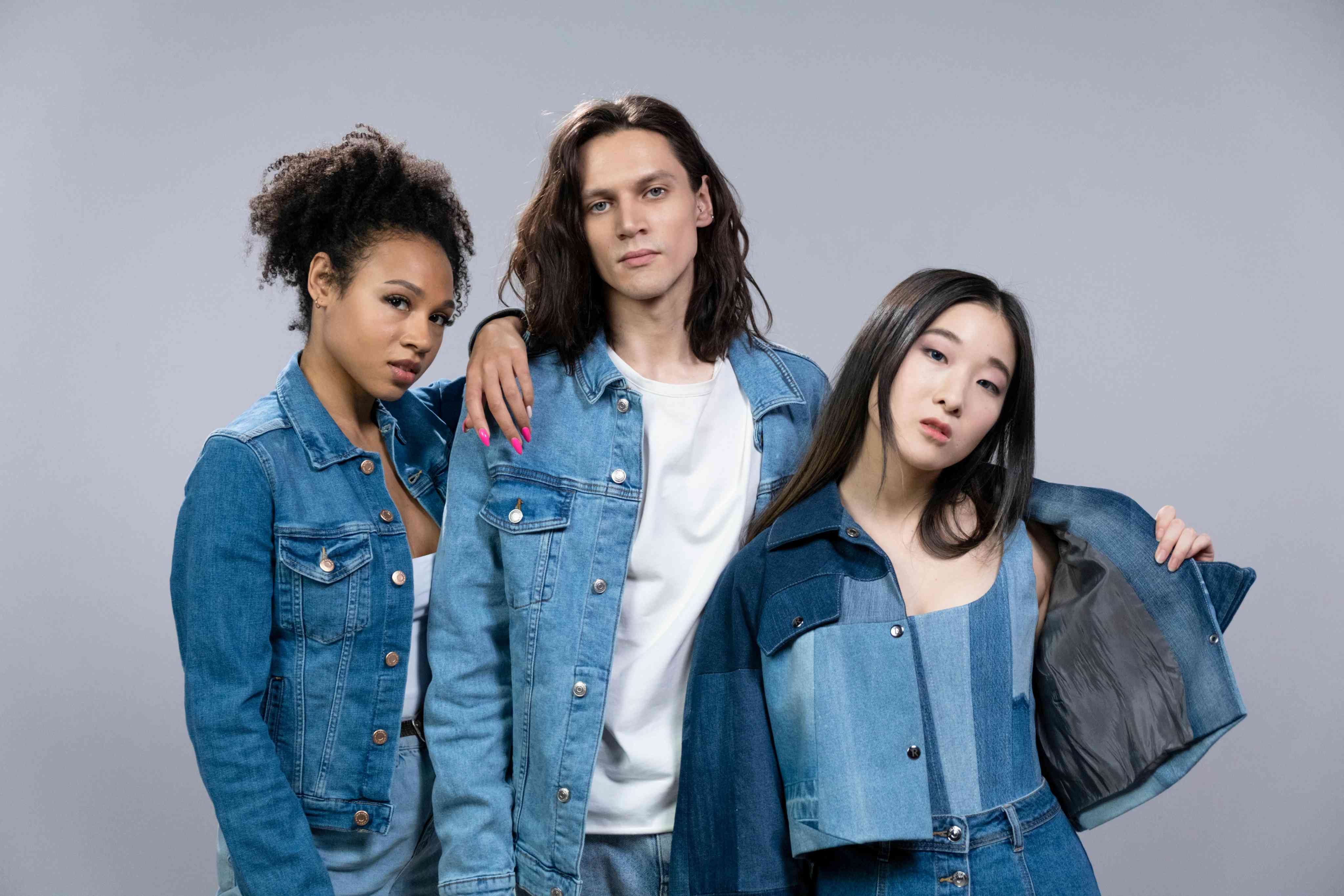 Two Women and Man In Blue Denim Outfits