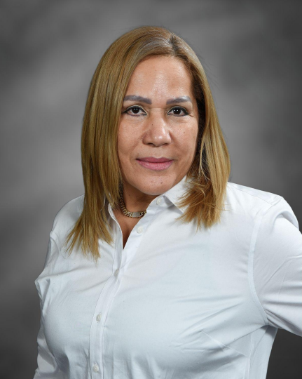 Ms. Genara Ortiz smiling in a professional staff portrait