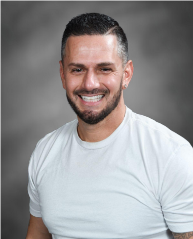 Mr. Kristopher Indelicato smiling in a gray Nike hoodie
