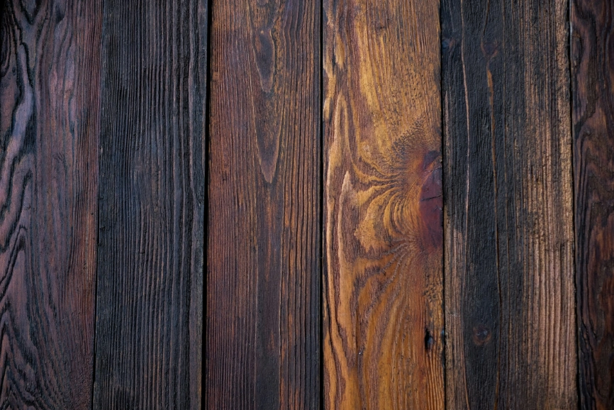 a close up photo of rich brown wooden decking boards