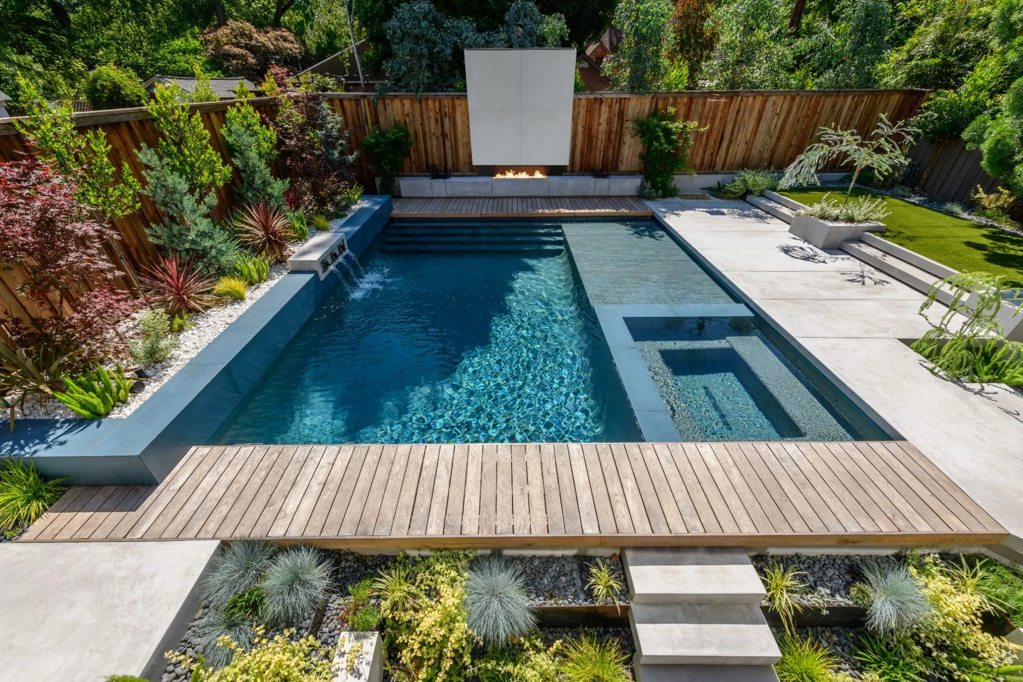 Luxury decking patio surrounding a backyard pool