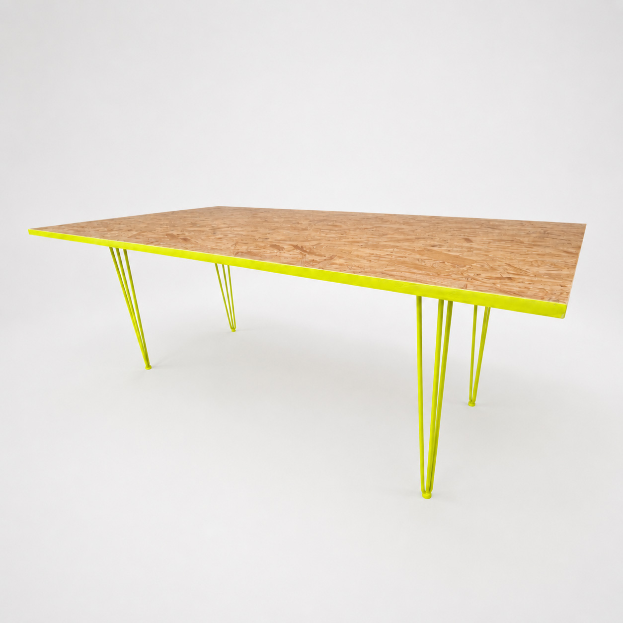 Rectangular wooden table with bright yellow hairpin metal legs on a white background.