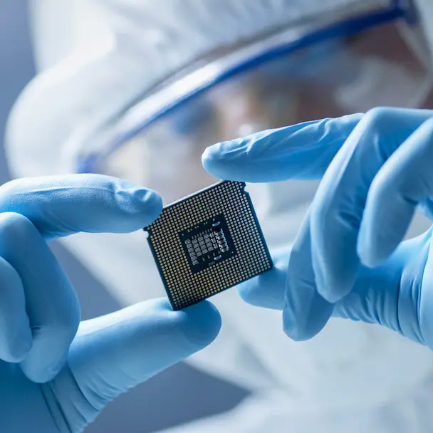 A scientist holding a microchip in hands