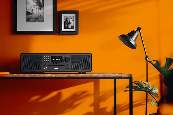 Sonoro-Radio auf einem Tisch vor oranger Wand, Produktpräsentation