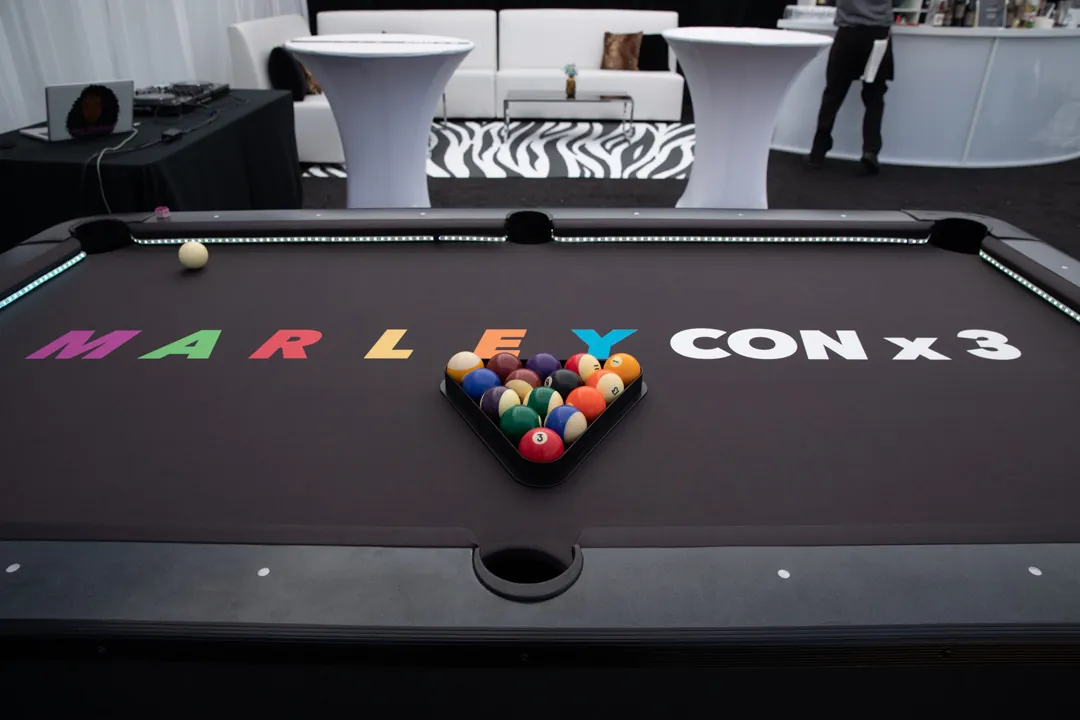 Pool table with custom MarleyCon x 3 felt and racked balls in the adult lounge at The Executive Hangar