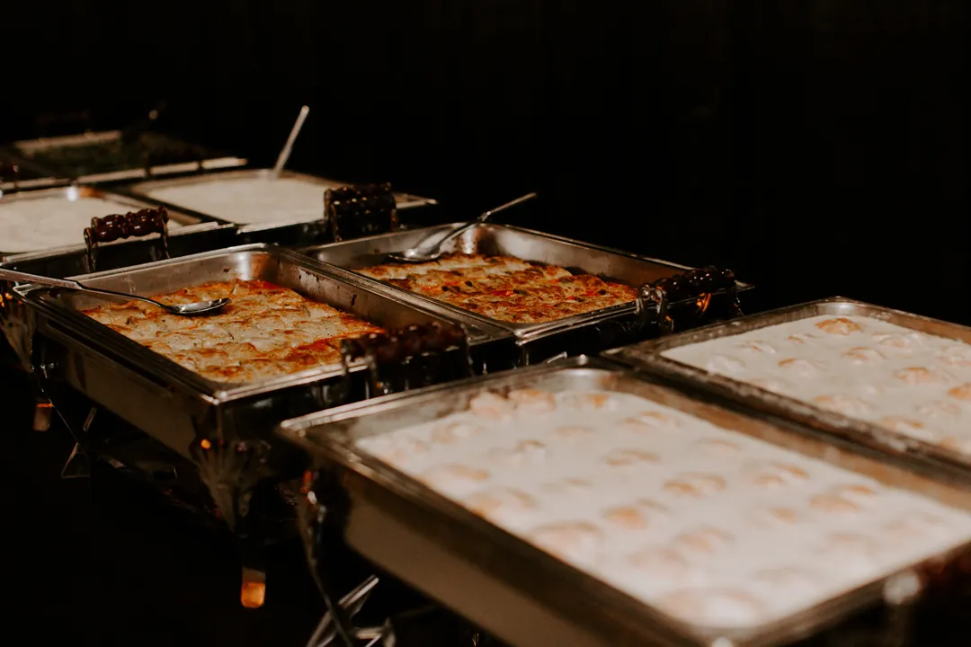 Chafing dishes of baked pasta and creamy scalloped potatoes on the Jay's Catering dinner buffet